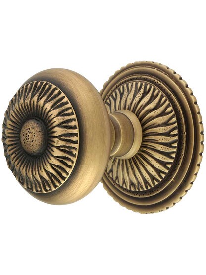 Sunburst Rosette with Sunburst Door Knobs in Antique Brass.
